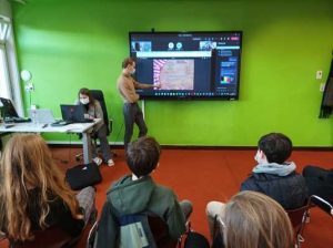 Students in the classroom interacting with others on the screen
