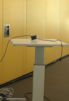 Image of a laptop lectern with a HDMI cable threaded through a roll of gaffertape