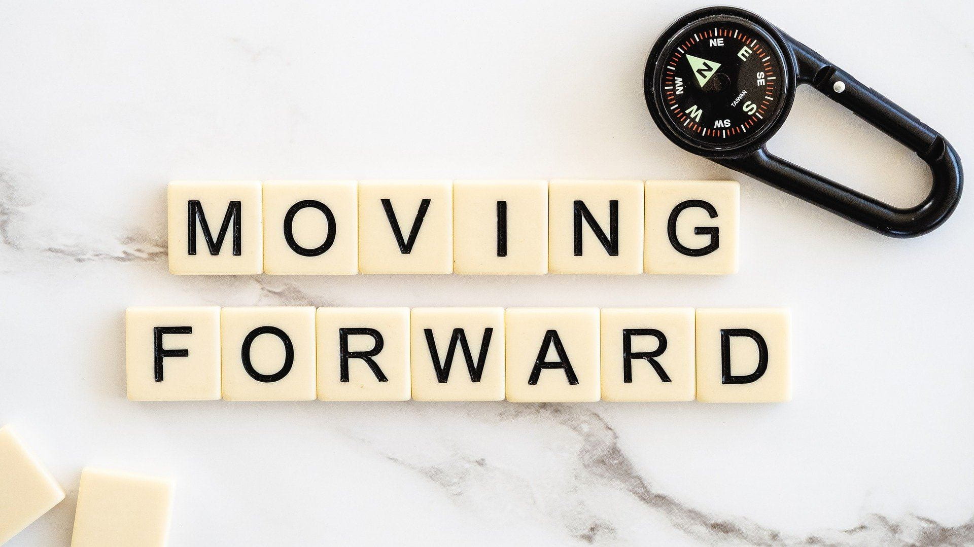 Moving forward laid out in scrabble tiles