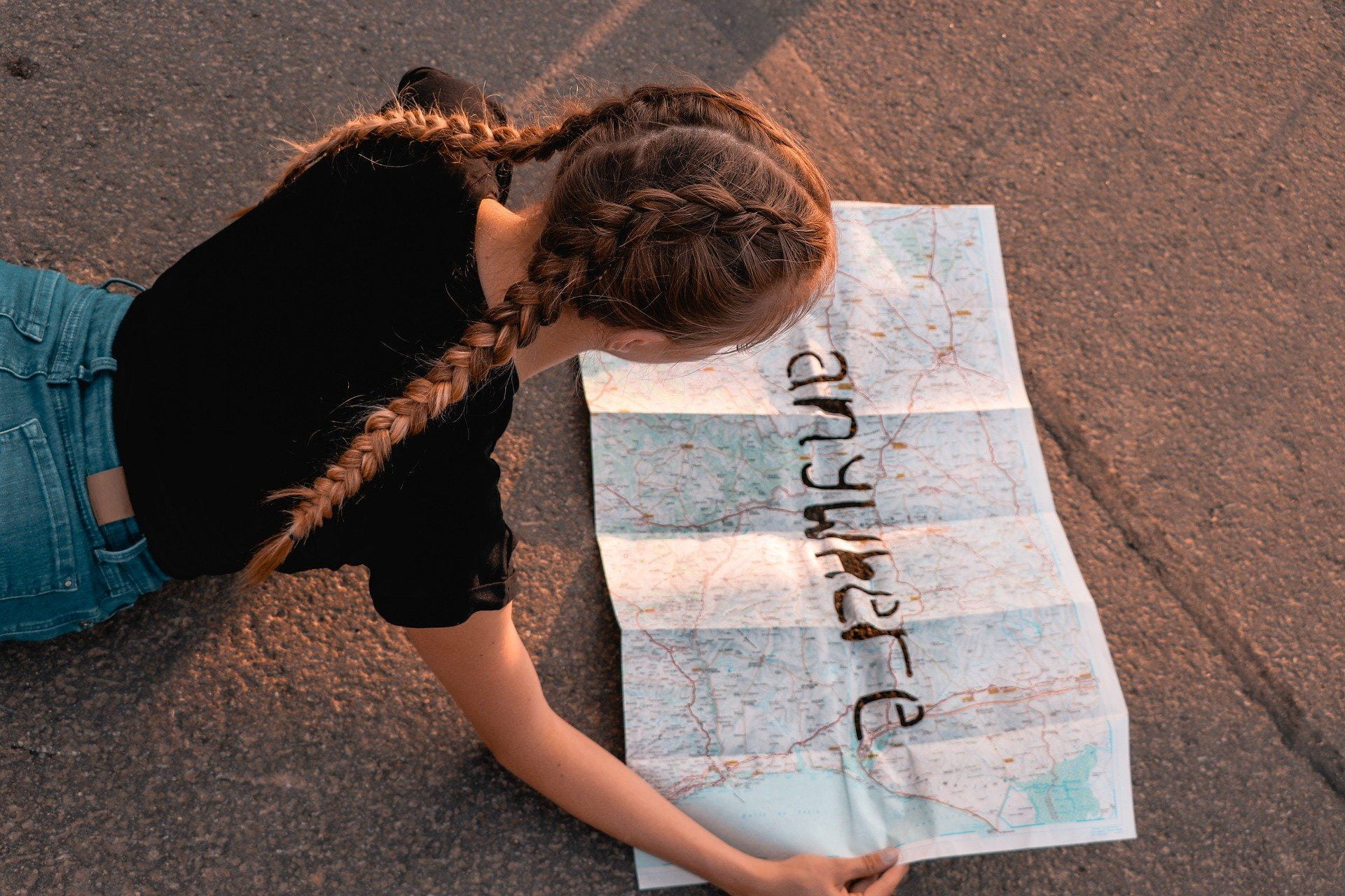 Girl looking at map with anywhere written on it
